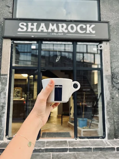 Shamrock Sports Bar facade with a coffee cup in foreground
