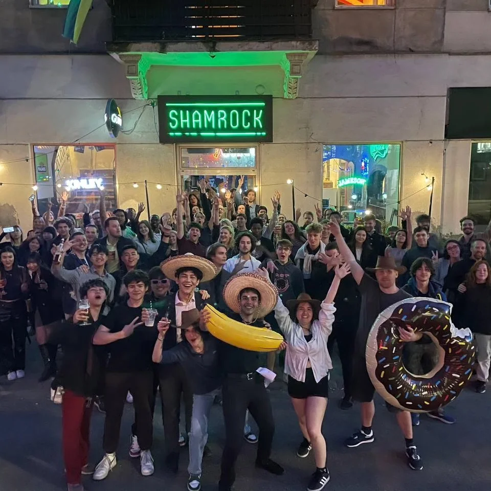 Crowd spilling onto the street outside the Classic at night, themed party in full swing, the Shamrock neon sign overhead