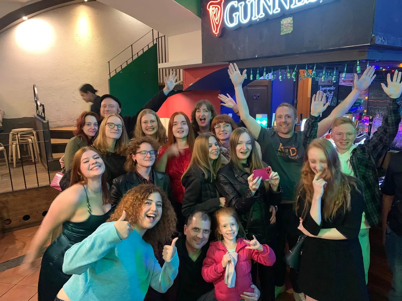 Group at the bar with pints of Guinness