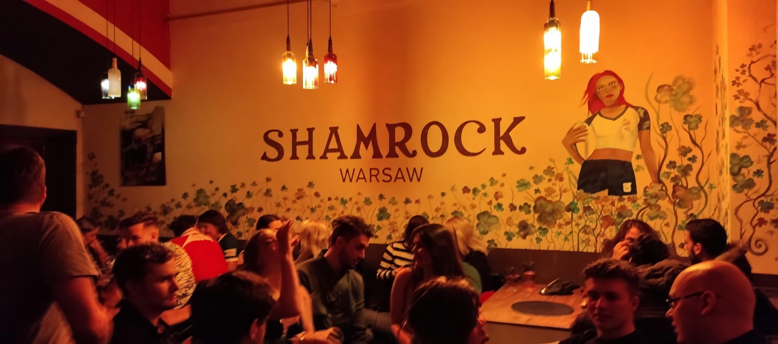 Upstairs room during Wednesday language exchange, regulars at tables talking across languages