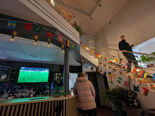 Staircase, flags overhead, bar with the match on